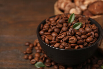 Fototapeta premium Coffee beans and mushrooms on wooden table, closeup. Space for text