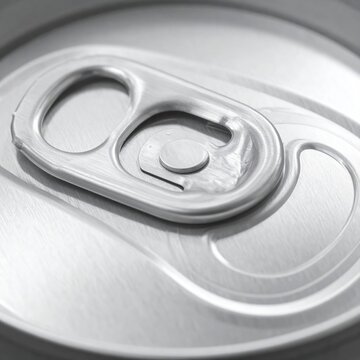Extreme close-up of a silver beverage can tab and opening mechanism