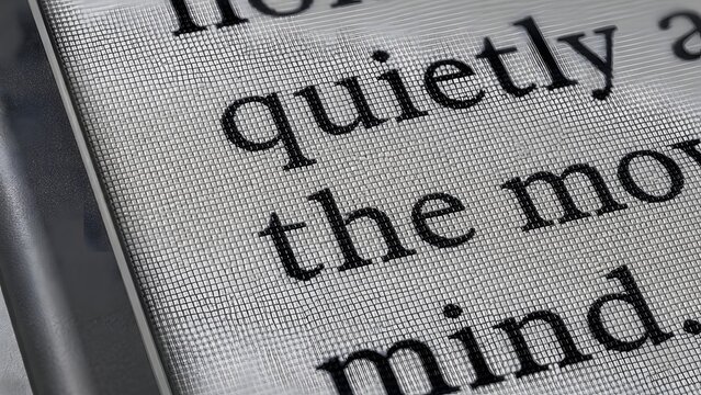 Macro Close Up of Digital Ebook Reader Screen Displaying Text with Electronic Ink Technology