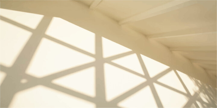A modern building interior featuring a structure of wooden ceiling patterns and large glass windows that fill the architectural design with natural light from the sky outside