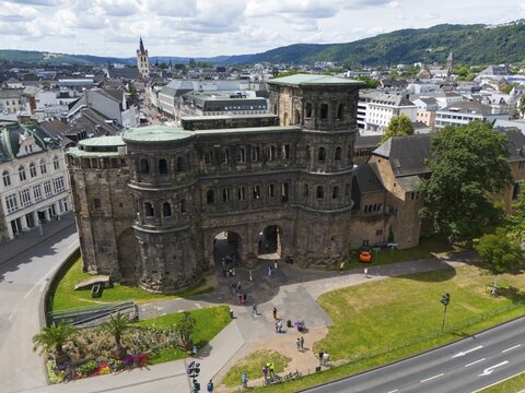 Historical architecture of the Porta Nigra with city panorama, surrounded by mountains and green areas, aerial view, Porta Nigra, Black Gate, Roman city gate, Trier, Rhineland-Palatinate, Germany