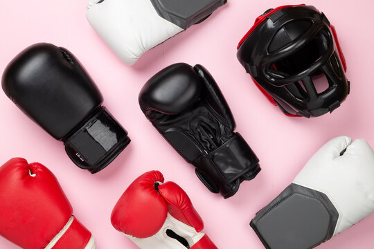 Boxing helmet and gloves on color background, top view.