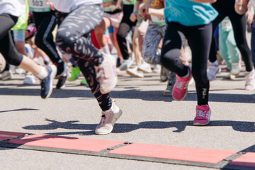 Naklejka premium Children marathon runners crowd, young teen sportsmen participants start running in the city streets, crowd of kids joggers in motion, kid group athletes outdoor run, family competition in summer day
