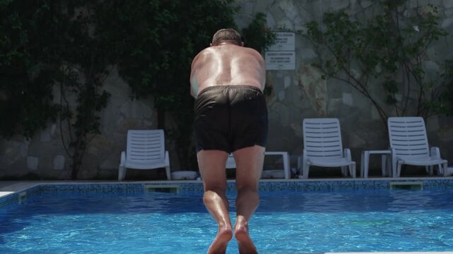 Man Jumps Head First Into Swimming Pool Creating Large Splash