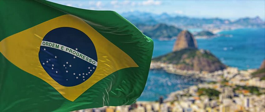 Brazil flag green yellow blue sky city harbor mountain travel landmark vibrant national flag waving over sunny coastal city bay and ocean coast harbor landscape summer tourism patriotism wave windy