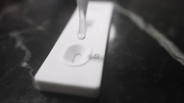 Liquid Dropping on Covid Rapid Test for Infection Diagnosis Close Up