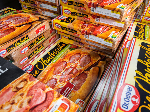 Frozen Pizza Boxes Stacked in Grocery Store Aisle