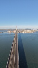 Aerial view of the Constitution of 1812 Bridge in Cadiz, Spain. Cinematic drone shot of the modern landmark cable-stayed bridge over the bay on a sunny day