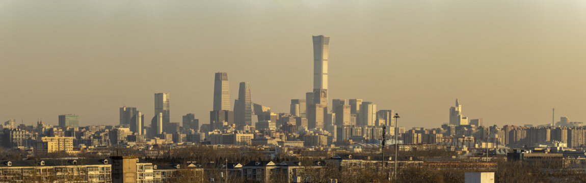 View of the Beijing CBD skyline featuring the China Zun tower and modern skyscrapers under a hazy golden sky in Beijing, Beijing, China.