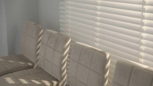 Many stylish chairs near window in office. Camera moving down and zooming in
