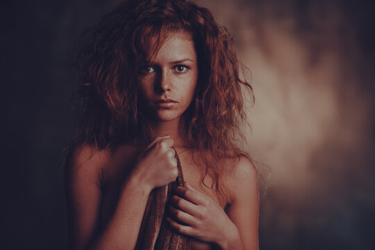 Beauty portrait of young woman with red hair and freckles