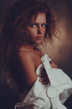 Sensual portrait of a beautiful young woman with red hair and freckles