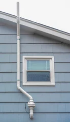 close up on house with radon mitigate system installed © nd700