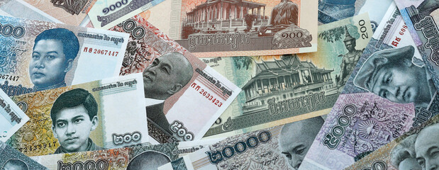 Cambodian riel money banknotes pile on table. Cambodia bills of KHR currency close up © Larysa