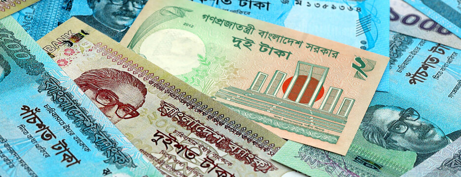 Bangladeshi taka money banknotes pile on table. Bangladesh bills of BDT currency close up
