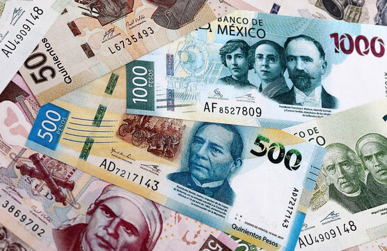Mexican peso money banknotes pile on table. Mexico bills of MXN currency close up