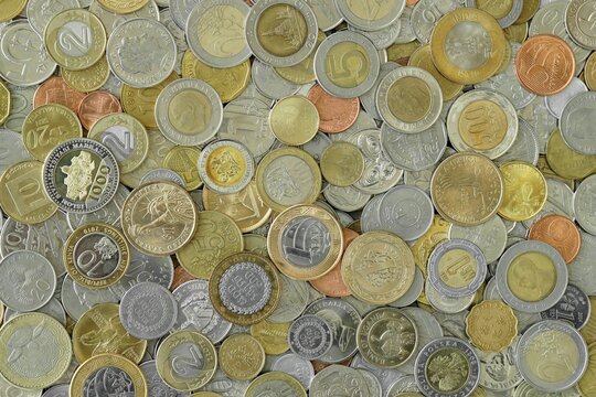 Scattered coins of multiple origins in big mound, detailed shot. World currency variety