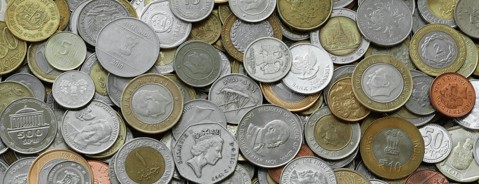 Scattered coins of multiple origins in big mound, detailed shot. World currency variety