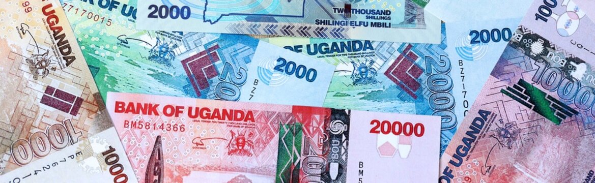 Ugandan shilling money bills in pile on table. Uganda UGX currency cash close up