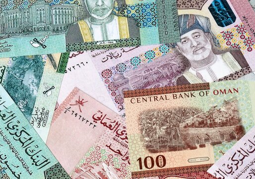 Omani rial money bills in pile on table. Oman OMR currency cash close up