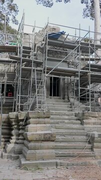 SIEM REAP, CAMBODIA, 27 October 2025 &ndash; A worker carries a bucket at the ancient temple of Beng Mealea, which is undergoing restoration and preservation work. Angkor Wat