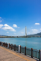 Fototapeta premium Beautiful riverbank boardwalk view of danjiang bridge in taiwan