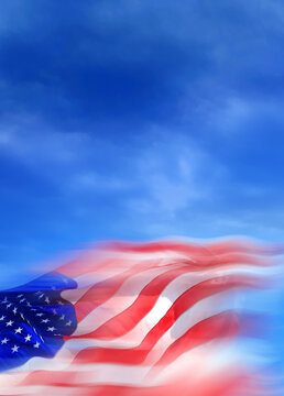 Close up blurred motion American flag in dramatic blue sky