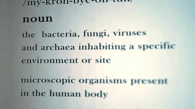 Microbiota definition animated text representing clinical microbial taxonomy classification and microflora sequencing science education in 4K Ultra HD footage
