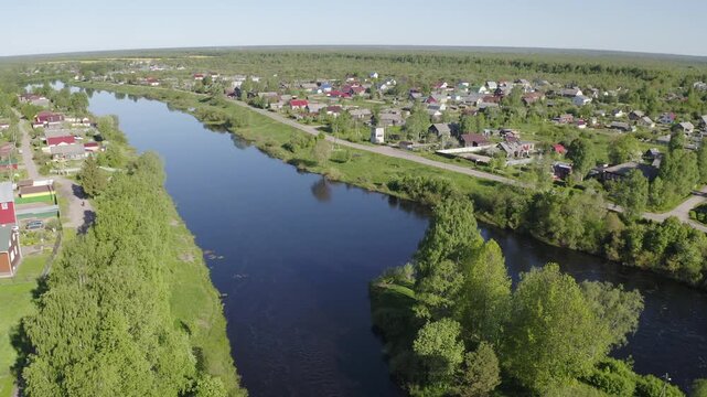 Backward reveal aerial shot of Smolensky cathedral and bridges over Olonka river on sunny summer day. Olonets, Karelia, Russia.