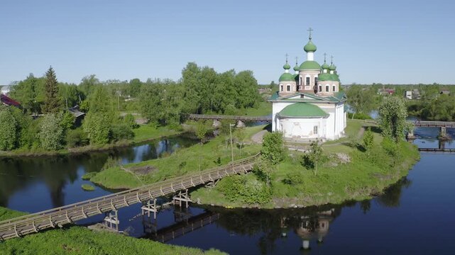 Forward reveal aerial footage of Smolensky cathedral and Olonka river on sunny summer day. Olonets town, Karelia, Russia.