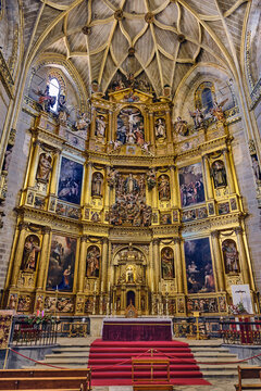 Plasencia, Spain - 03 December 2025: View of the ornate golden altarpiece and vaulted ceiling inside the Catedral Nueva de Plasencia.