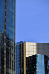 Obraz premium Modern glass office buildings with blue sky copy space