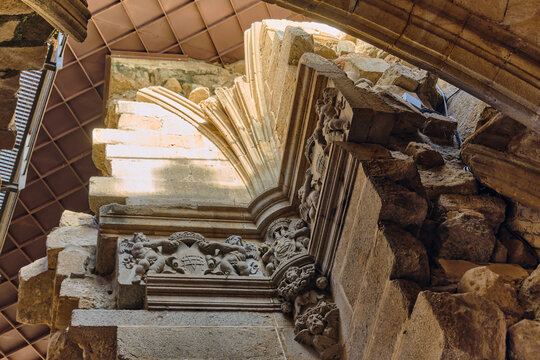 Plasencia, Spain - 03 December 2025: View of Catedral Nueva de Plasencia featuring intricate stone carvings of cherubs and heraldic shields under a vaulted ceiling.