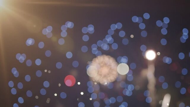 A patriotic fireworks display with a red and white bokeh effect.
