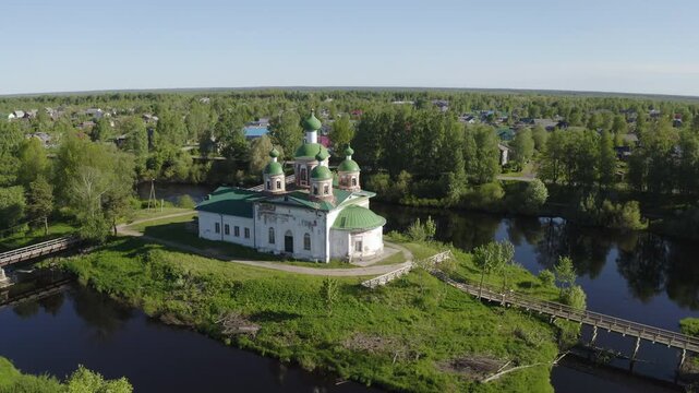 Drone footage of Smolensky cathedral and Olonka river on sunny summer day. Olonets town, Karelia, Russia.