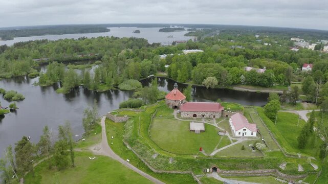 Forward reveal aerial shot of Korela fortress on cloudy summer day. Priozersk, Leningrad Oblast, Russia.