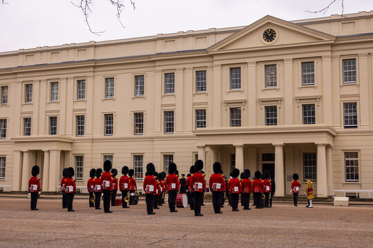 London, United Kingdom - 12 May 2025: View of the King's Guard in red tunics and bearskin hats standing in formation in front of the Horse Guards building.