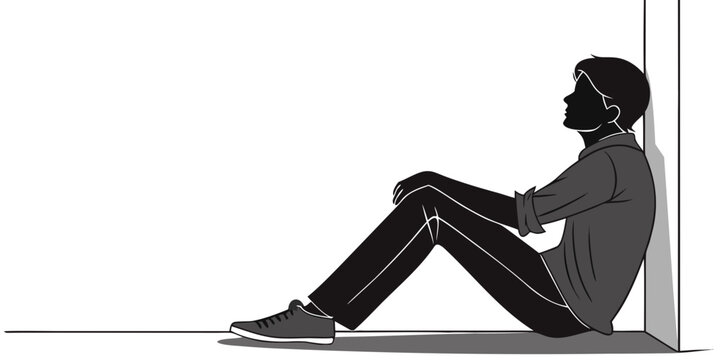 Silhouette of a man sitting on the ground leaning against a wall and looking up while deep in thought or reflection with state of mind mental health looking up silhouette contemplation thinking
