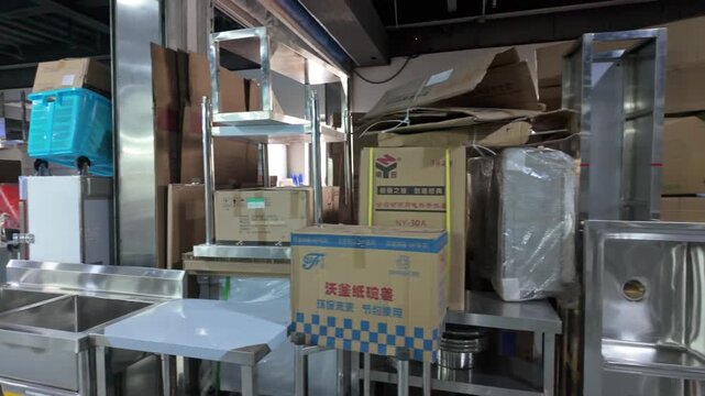 The cardboard boxes and metal equipment piled up in the warehouse