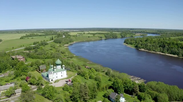 Aerial footage of John the Baptist cathedral (1695) and Volkhov river on sunny summer day. Staraya Ladoga, Leningrad Oblast, Russia.