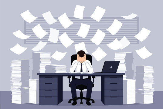 Overwhelmed businessman sitting at a desk with piles of work while numerous papers fly through the air around him in a panic.