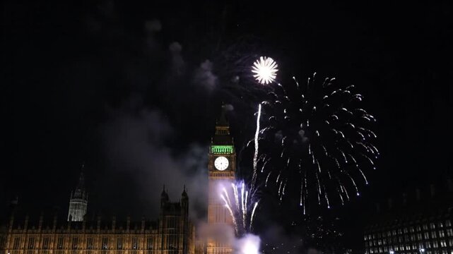 Blue fireworks exploding over iconic clock tower at night