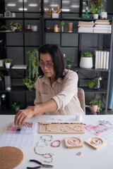 Fototapeta premium Mature asian woman&nbsp;making handmade jewellery accessories handcraft hobby