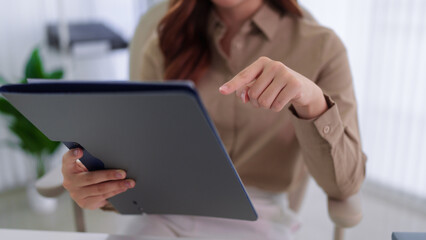 business woman using digital tablet touchscreen browsing online information working at modern office workspace standing professional caucasian corporate © Audtakorn