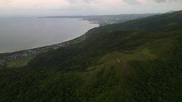 Picturesque aerial orbit of Catanduanes, Philippines with lush tropical hills, forested terrain, and a coastal island landscape by the sea