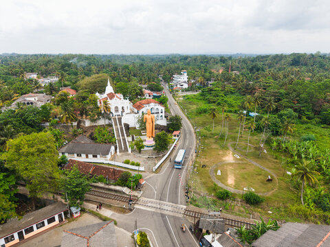 Aerial view of the Kumarakanda Kumara Maha Viharaya Royal Prince Temple of Kumarakanda with its white stupa and golden Buddha statue in Hikkaduwa, Southern Province, Sri Lanka.