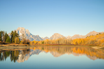 Fototapeta premium Panoramic view of Mount Moran and the Teton Range reflected in the Snake River at Oxbow Bend