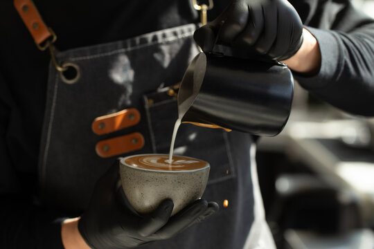 Barista finishing beautiful leaf latte art design