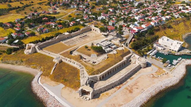 Seddulbahir, Eceabat, Turkey. Sedd el Bahr Fortress, angular stone bastions and earthen ramparts, aerial view over turquoise Dardanelles waters on a clear summer day. Aerial View, Departure of the ca