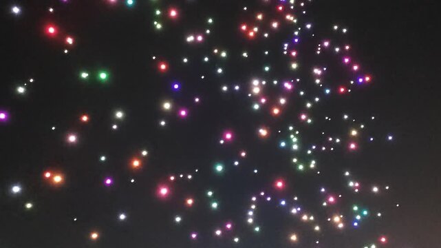A swarm of drones performing at night.